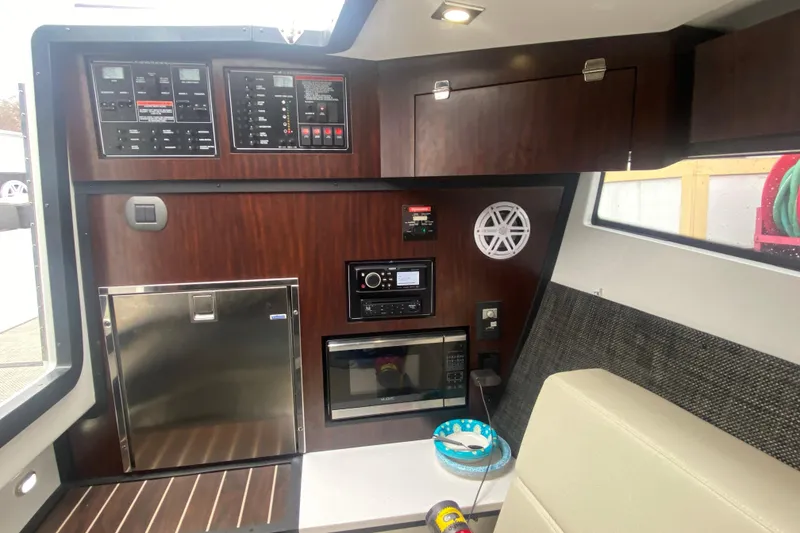 Slide: The Image of Interior of 2020 Monterey 385 Super Express yacht with control panels and modern amenities. - 21