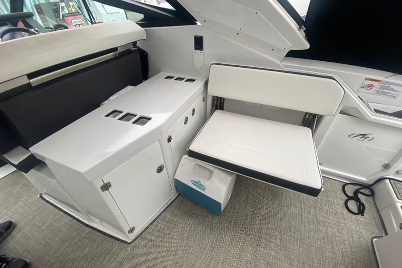 Slide: The Image of 2020 Monterey 385 Super Express interior with white seating and storage compartments. - 28