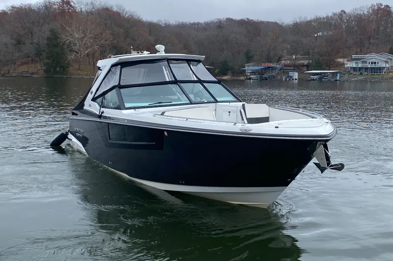 Slide: The Image of 2020 Monterey 385 Super Express boat on a calm lake with wooded shoreline. - 3