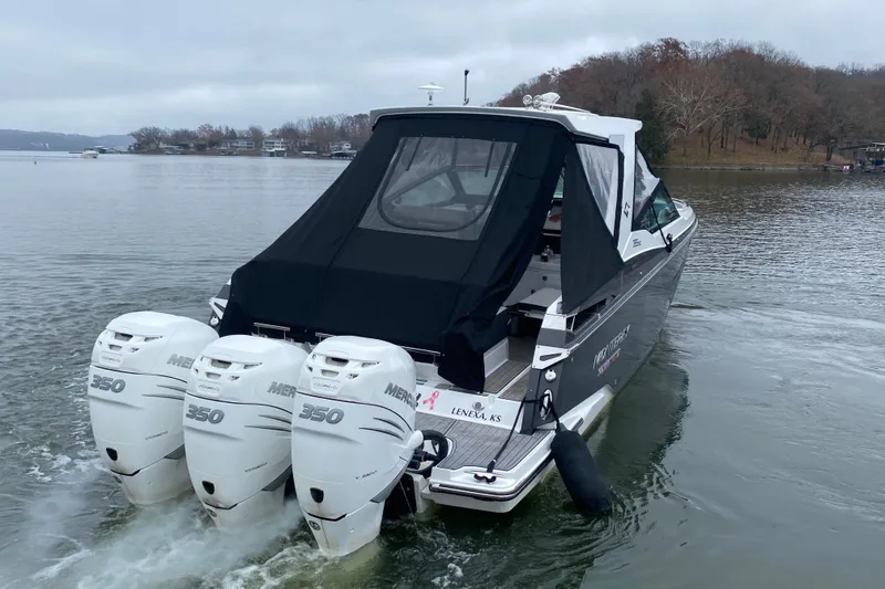 Slide: The Image of 2020 Monterey 385 Super Express boat with triple Mercury 350 engines on a lake. - 36