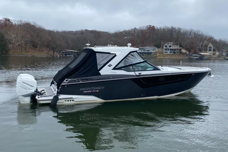 Slide: The Image of 2020 Monterey 385 Super Express boat on a calm lake with wooded shoreline. - 6
