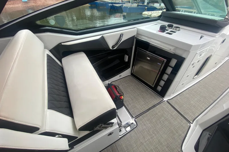 Slide: The Image of 2020 Monterey 385 Super Express interior with seating, mini-fridge, and modern design. - 14