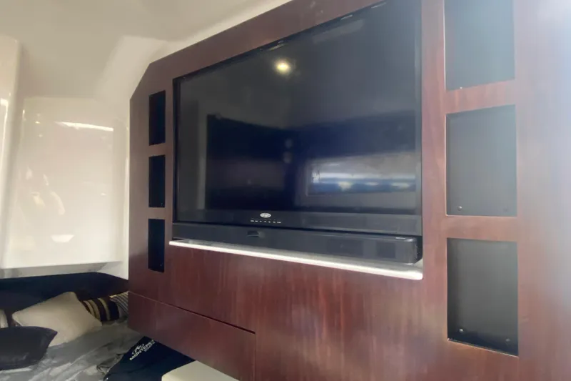 Slide: The Image of Interior of 2020 Monterey 385 Super Express with built-in TV and wood paneling. - 22