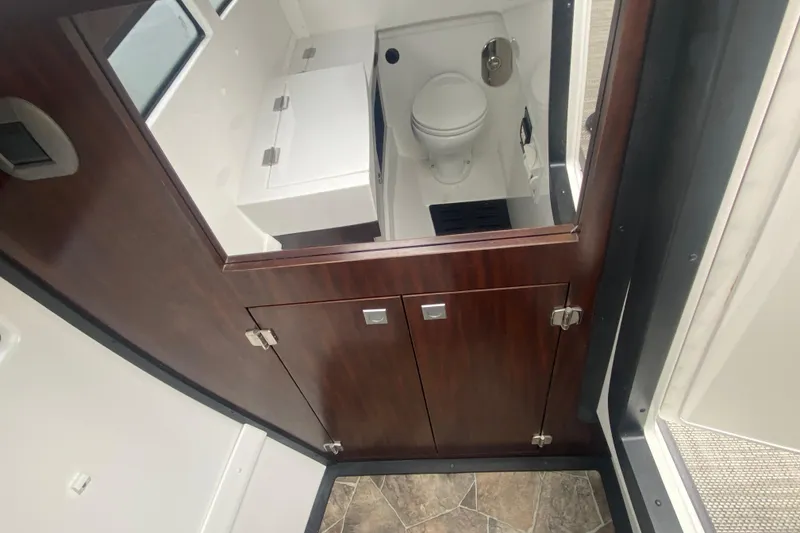 Slide: The Image of 2020 Monterey 385 Super Express bathroom interior with wood cabinetry and modern fixtures. - 25