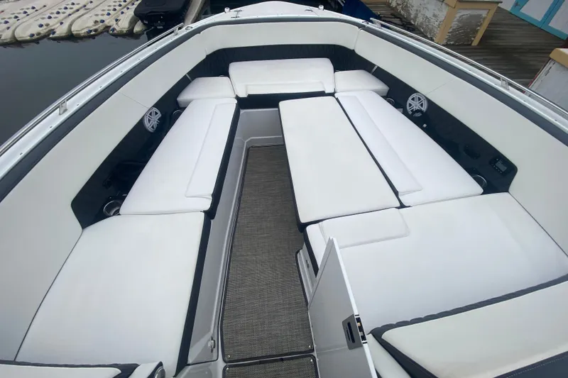 Slide: The Image of 2020 Monterey 385 Super Express boat interior with white cushioned seating. - 26