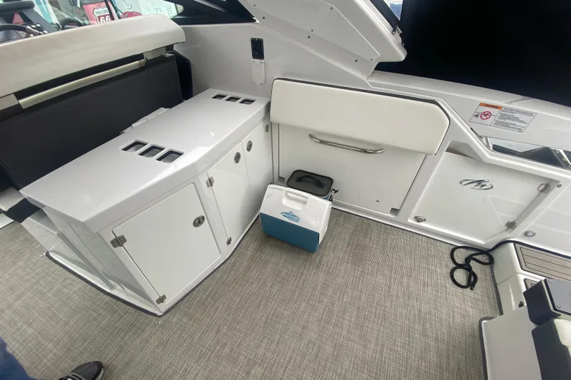 Slide: The Image of Interior of 2020 Monterey 385 Super Express boat with storage compartments and cooler. - 29