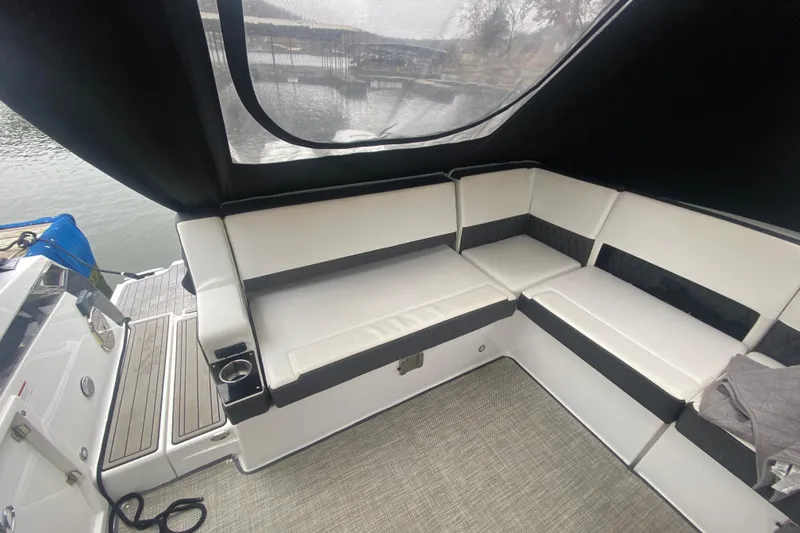 Slide: The Image of Interior of 2020 Monterey 385 Super Express boat with white seating and lake view. - 30
