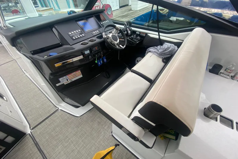 Slide: The Image of Cockpit of 2020 Monterey 385 Super Express boat with modern controls and seating. - 9
