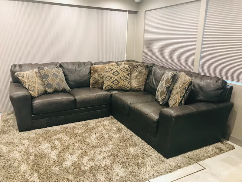 Slide: The Image of Brown leather sectional sofa with patterned cushions on a beige carpet, Adonia Inspiration Trip #9, 2019. - 10