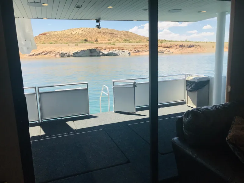 Slide: The Image of View from Adonia Inspiration Trip #9 houseboat, overlooking serene lake and rocky landscape, 2019. - 11