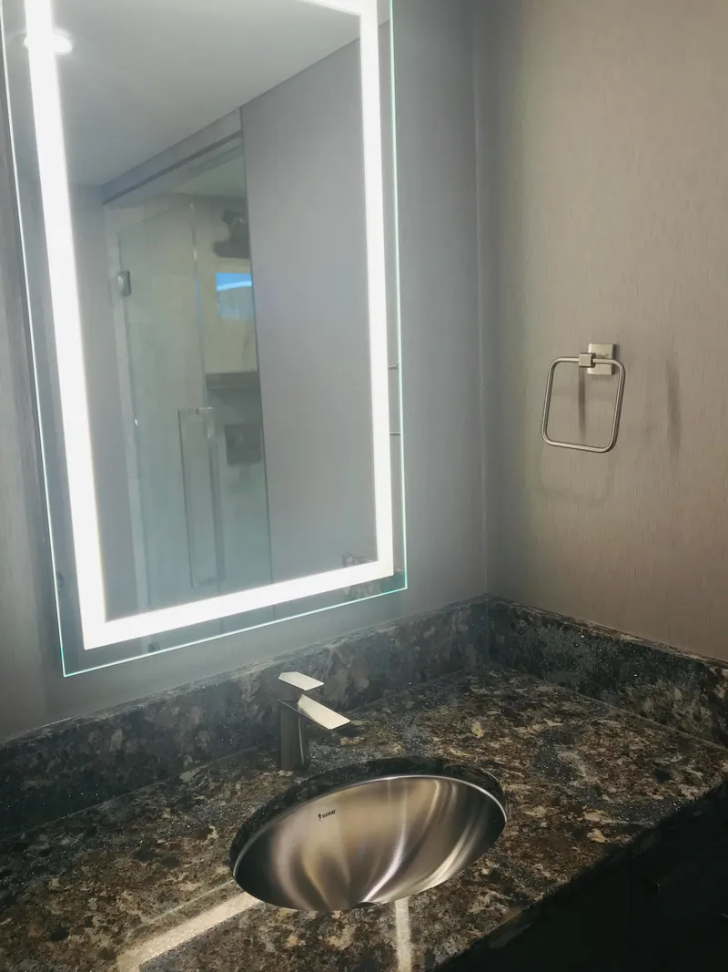 Slide: The Image of Modern bathroom with illuminated mirror, marble countertop, and stainless steel sink, Adonia Inspiration Trip #9, 2019. - 16