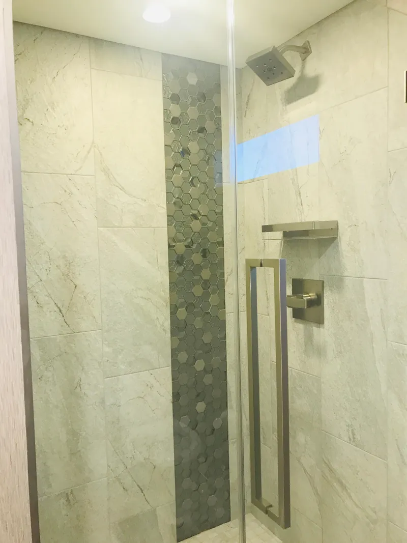 Slide: The Image of Modern shower with marble tiles and mosaic accent, featuring sleek fixtures. Adonia Inspiration Trip #9, 2019. - 17