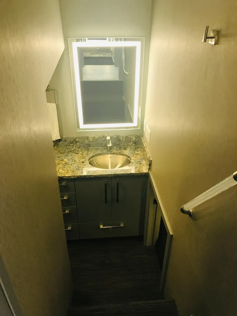 Slide: The Image of Compact bathroom with granite countertop and illuminated mirror in Adonia Inspiration Trip #9, 2019. - 23