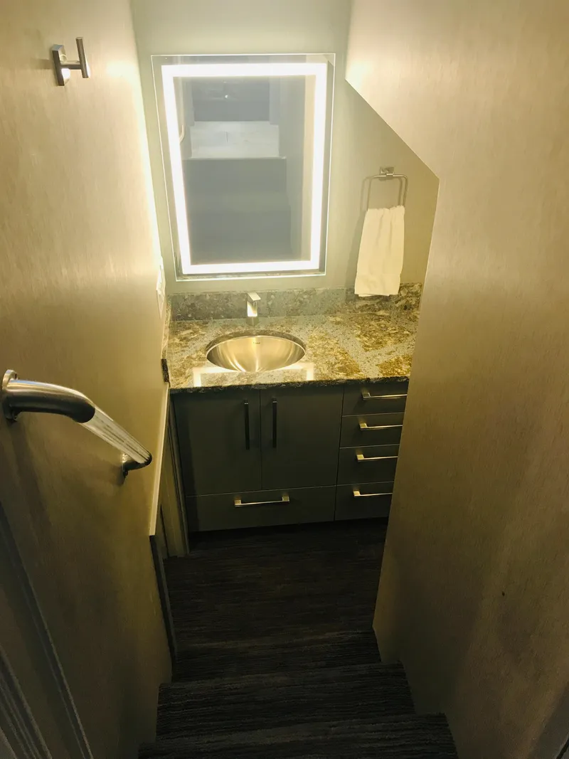 Slide: The Image of Compact bathroom with illuminated mirror, granite countertop, and modern sink in Adonia Inspiration Trip #9, 2019. - 26