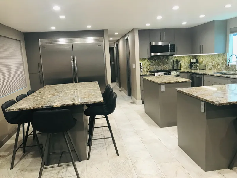 Slide: The Image of Modern kitchen with granite countertops, stainless steel appliances, and sleek cabinetry, Adonia Inspiration Trip #9. - 3