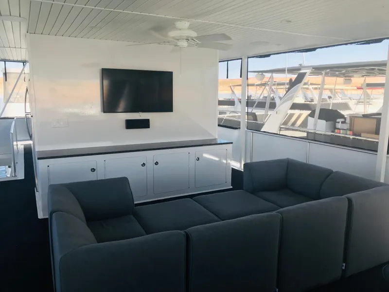 Slide: The Image of Modern boat interior with gray seating, TV, and white cabinetry. Adonia Inspiration Trip #9, 2019. - 33
