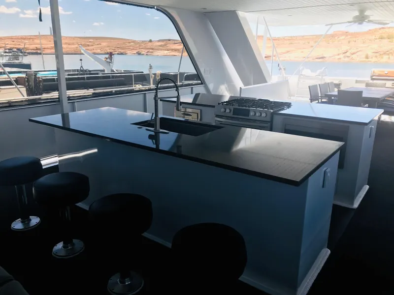 Slide: The Image of Modern kitchen on Adonia Inspiration Trip #9 houseboat, 2019, with sleek countertops and bar stools. - 34