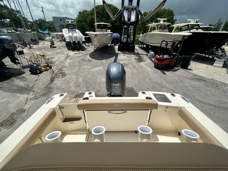 Slide: The Image of 2025 Scout 215 XSF boat at a marina with other boats and equipment. - 3