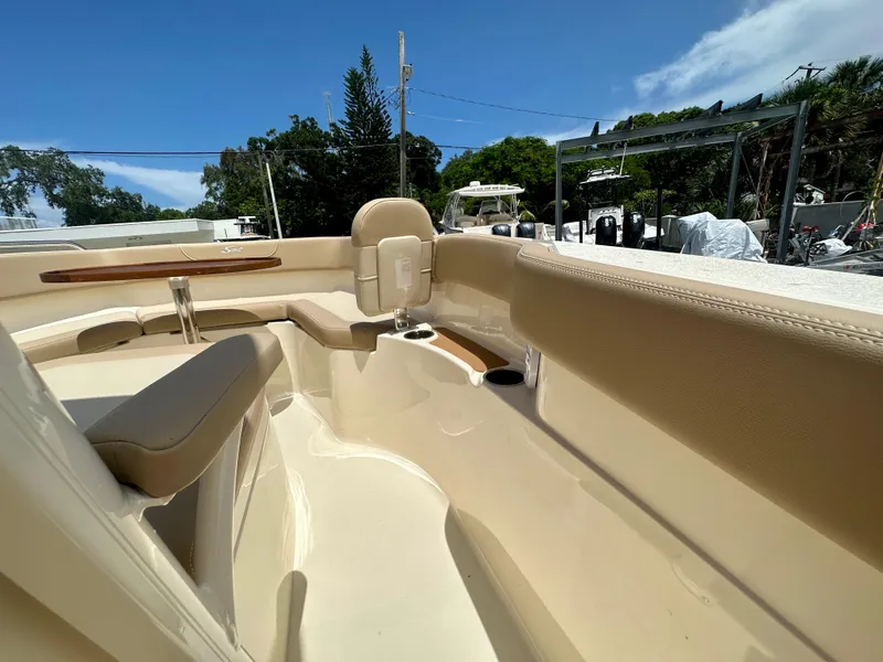 Slide: The Image of Interior view of 2025 Scout 215 XSF boat with beige seating and wooden accents. - 5