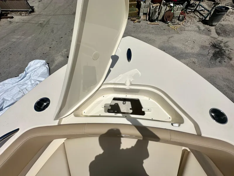 Slide: The Image of 2025 Scout 215 XSF boat with open storage compartment on deck. - 6