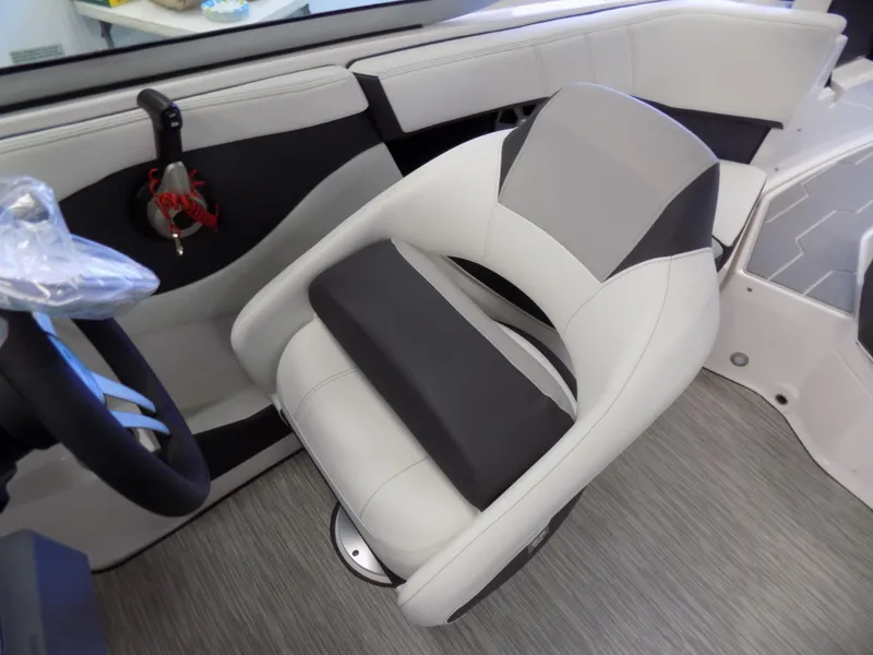 Slide: The Image of 2023 Regal 21 OBX boat interior with modern seating and steering wheel. - 11