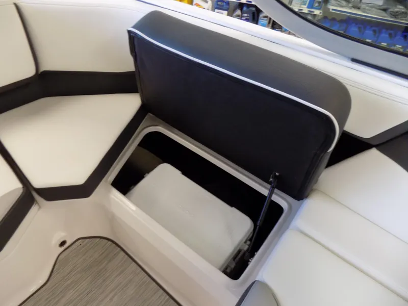 Slide: The Image of 2023 Regal 21 OBX boat interior storage compartment with cushioned seating. - 16