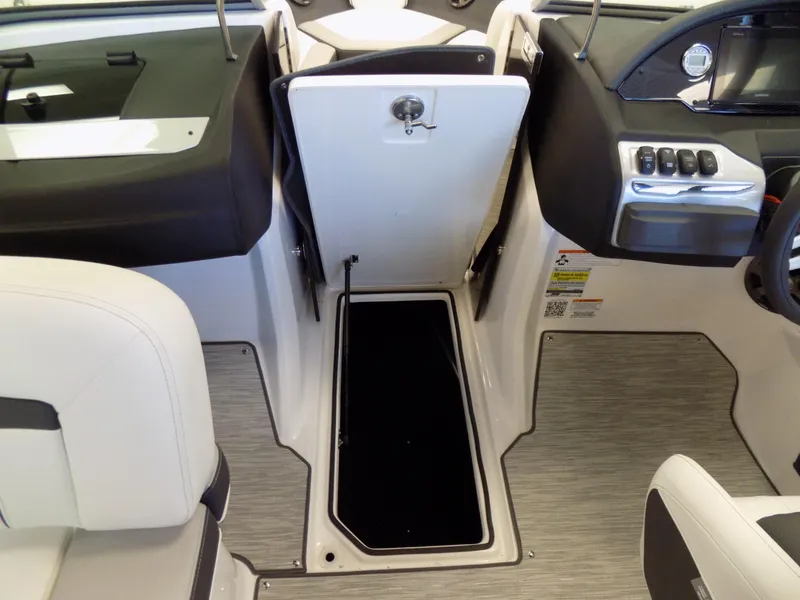 Slide: The Image of 2023 Regal 21 OBX boat interior with open storage compartment and modern dashboard. - 17