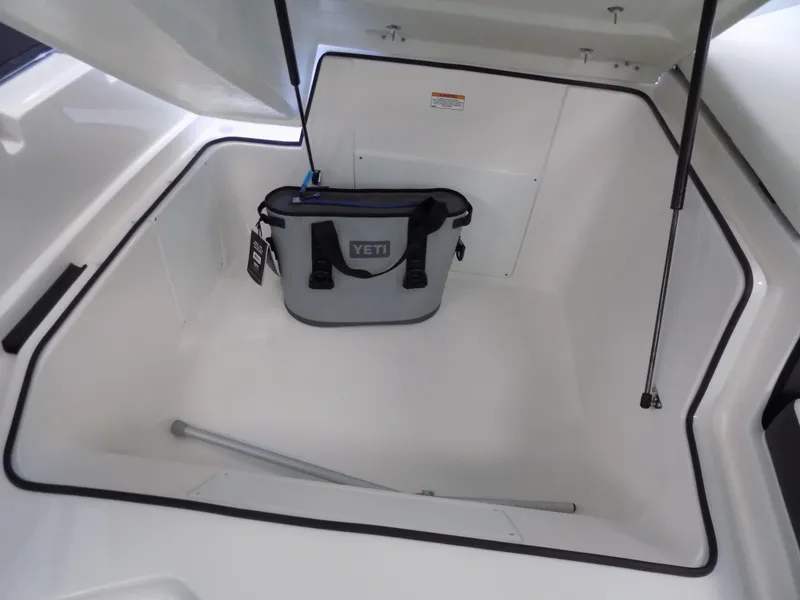 Slide: The Image of Storage compartment of 2023 Regal 21 OBX boat with Yeti cooler inside. - 18