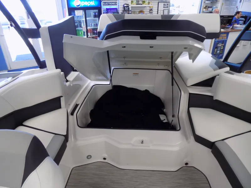 Slide: The Image of 2023 Regal 21 OBX boat interior with open storage compartment and seating. - 20