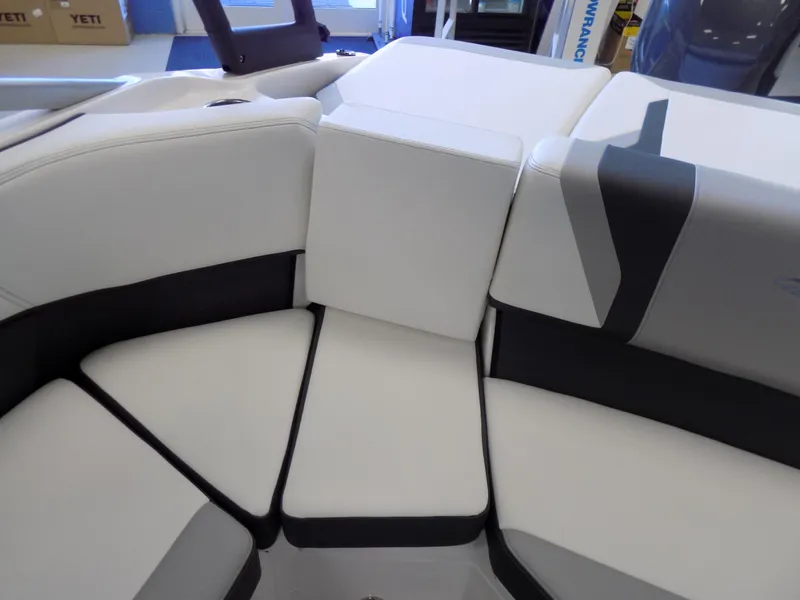 Slide: The Image of 2023 Regal 21 OBX boat interior seating with white and black upholstery. - 22