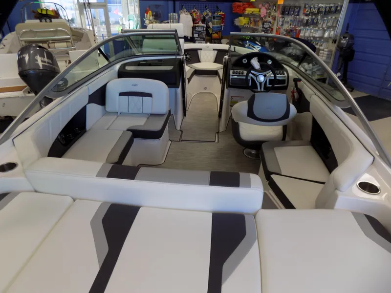 Slide: The Image of 2023 Regal 21 OBX boat interior with modern seating and sleek dashboard design. - 3