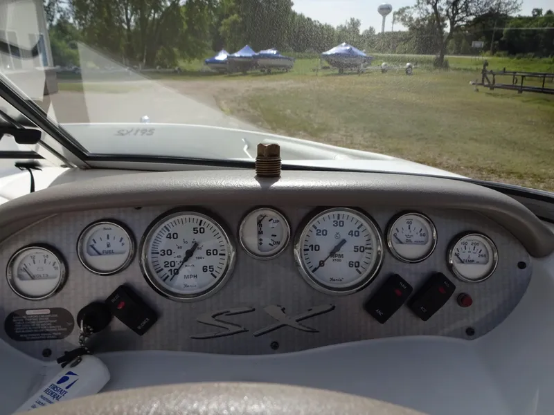 Slide: The Image of Dashboard of a 2005 Glastron SX195 boat with gauges and controls. - 11