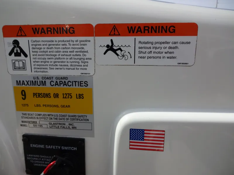 Slide: The Image of 2005 Glastron SX195 warning labels and capacity information with U.S. flag sticker. - 15