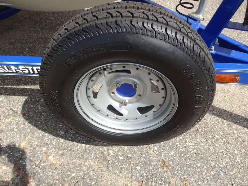 Slide: The Image of Trailer tire of a 2005 Glastron SX195 boat on a blue frame. - 17