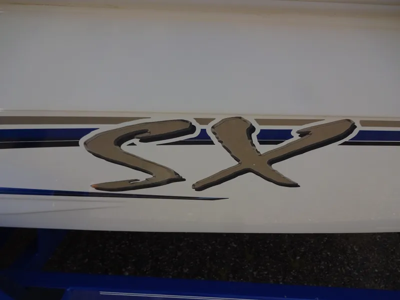 Slide: The Image of 2005 Glastron SX195 boat logo on white and blue hull. - 19
