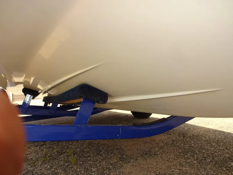 Slide: The Image of 2005 Glastron SX195 boat hull on blue trailer, close-up view. - 20