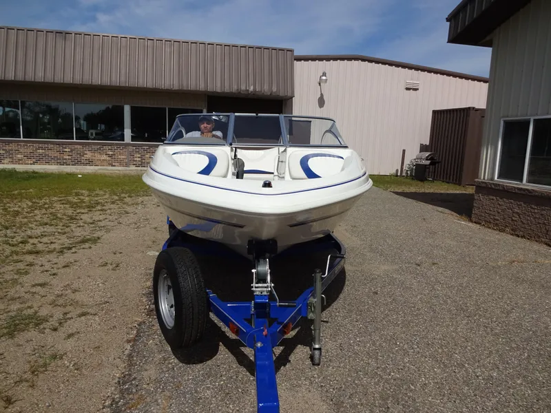 Slide: The Image of 2005 Glastron SX195 boat on trailer, parked outside a building. - 3