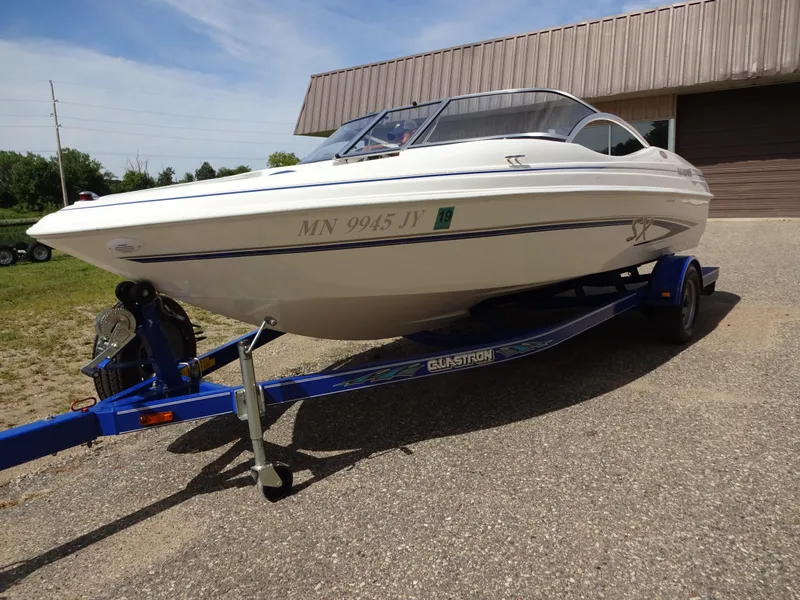 Slide: The Image of 2005 Glastron SX195 boat on trailer, parked outdoors. - 4