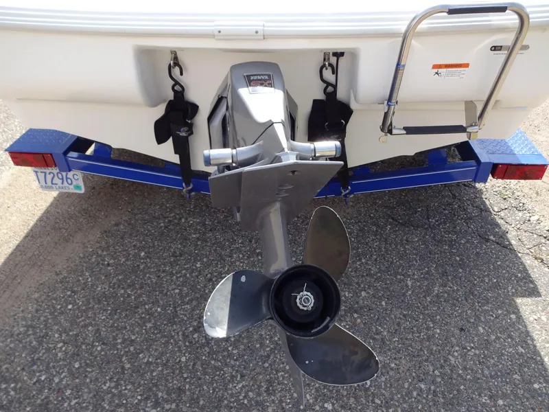Slide: The Image of Rear view of 2005 Glastron SX195 boat with visible propeller and trailer. - 7
