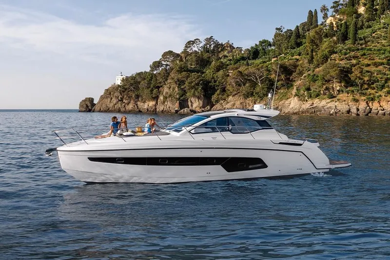 Slide: The Image of 2023 Azimut A45 yacht cruising near a scenic coastline. - 1
