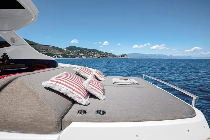 Slide: The Image of 2023 Azimut A45 yacht with sunbathing area and scenic ocean view. - 11