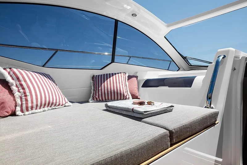 Slide: The Image of Luxurious sunbed area on the 2023 Azimut A45 yacht with striped pillows. - 14