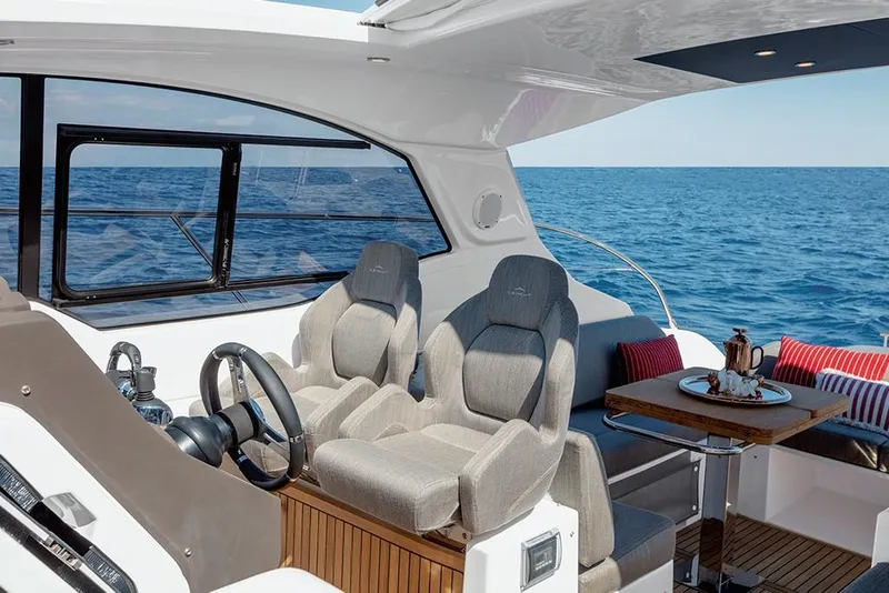 Slide: The Image of 2023 Azimut A45 yacht interior with helm seats and ocean view. - 18