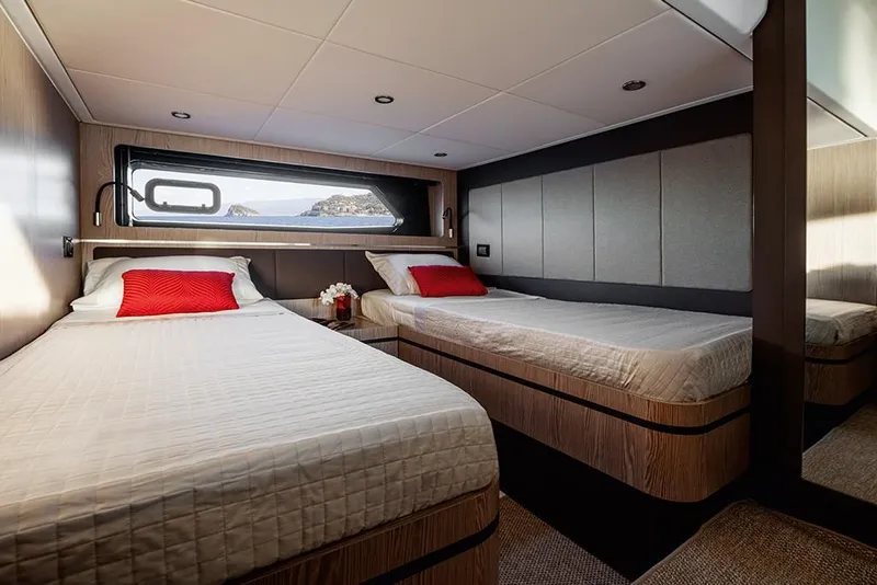 Slide: The Image of 2023 Azimut A45 yacht cabin with twin beds and modern decor. - 23
