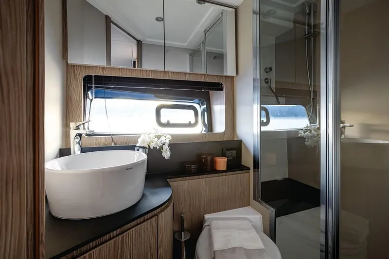 Slide: The Image of Modern bathroom in 2023 Azimut A45 yacht with sleek fixtures and a large window. - 25