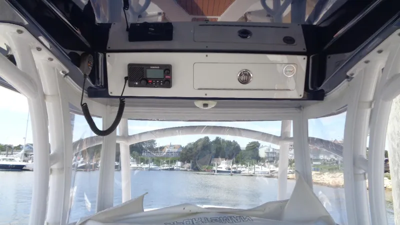 Slide: The Image of 2017 Sportsman 312 Open boat console with radio, overlooking marina. - 10