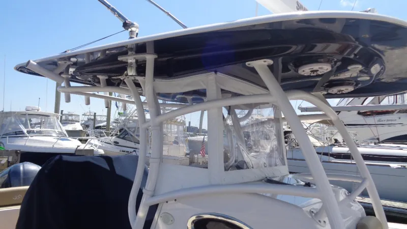 Slide: The Image of 2017 Sportsman 312 Open boat with T-top, docked among other vessels. - 14