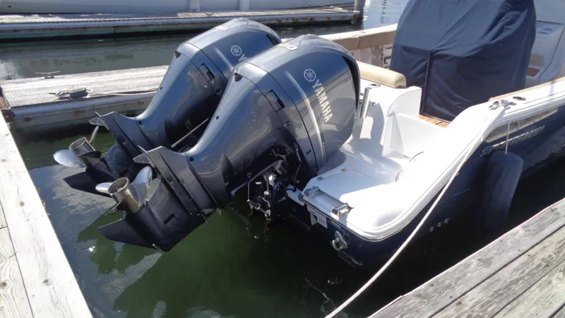 Slide: The Image of 2017 Sportsman 312 Open boat with dual Yamaha outboard engines docked at marina. - 17