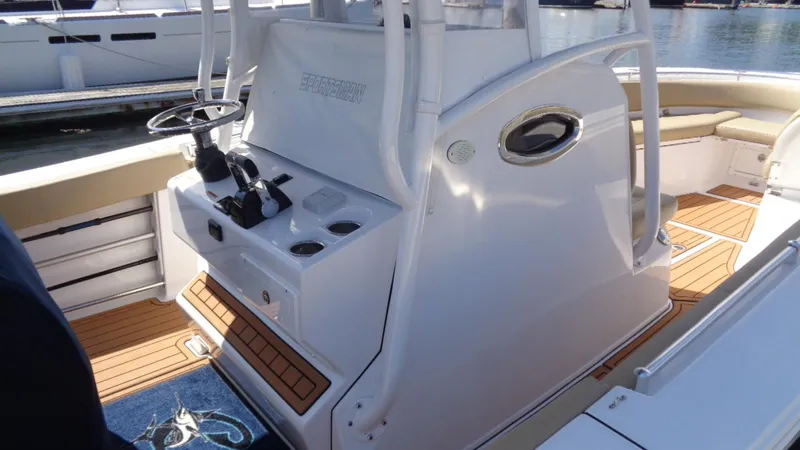 Slide: The Image of 2017 Sportsman 312 Open boat interior with helm, seating, and teak flooring. - 18