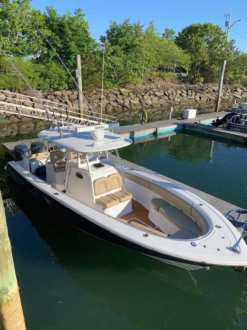 Slide: The Image of 2017 Sportsman 312 Open boat docked in a serene marina setting. - 19